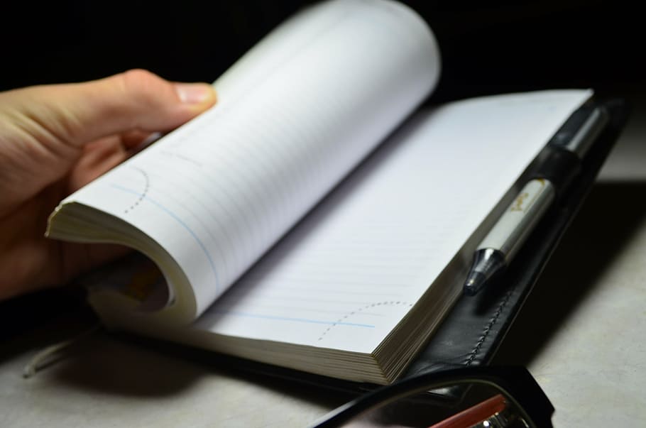 person flipping page of book, notebook, pen, hand, diary, office HD wallpaper