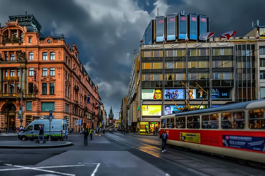 people and vehicles on street between buildings during daytime HD wallpaper