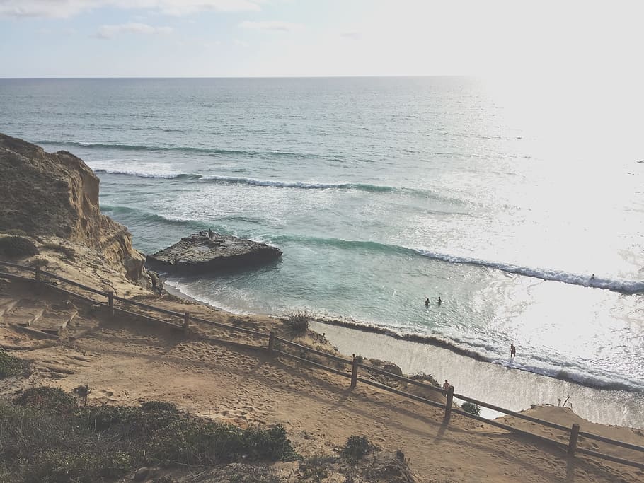 sea waves near rock formation, high angle view of people on shore HD wallpaper
