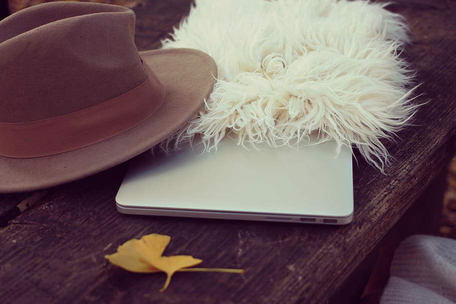 white fur with brown hat and white device on brown surface, wood - Material HD wallpaper