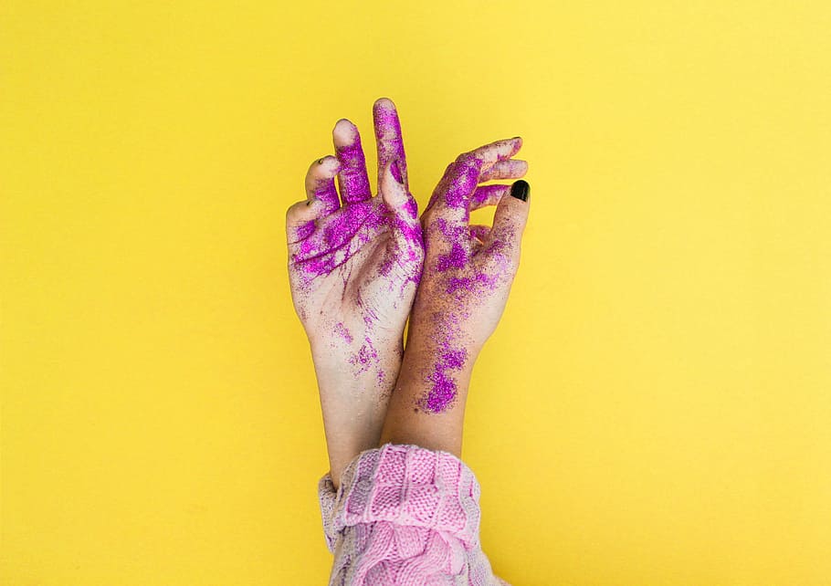 minimalist photography of person's hands with purple glitters, woman with purple powders in her hands HD wallpaper