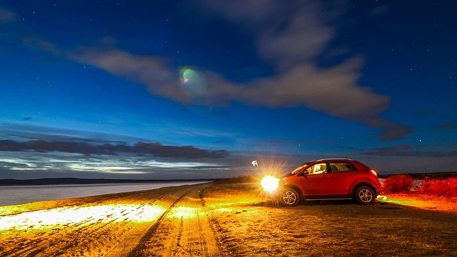 red SUV on sand bear body of water at night \, lake, starry sky HD wallpaper