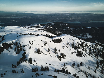 mountain with trees filled with snow during daytime, aerial photography of mountains HD wallpaper