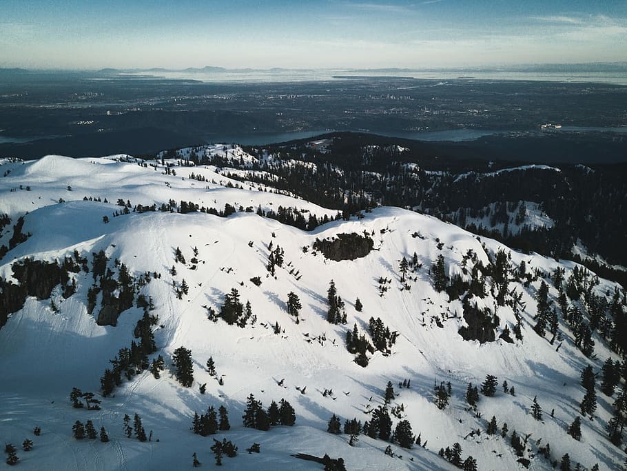 mountain with trees filled with snow during daytime, aerial photography of mountains HD wallpaper