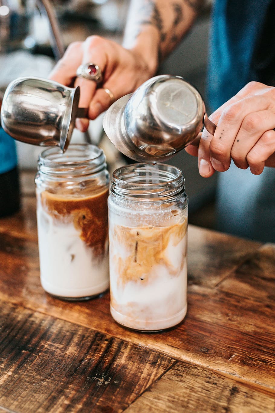 person pouring liquid on drinking glasses, person pouring creamer into jar HD wallpaper