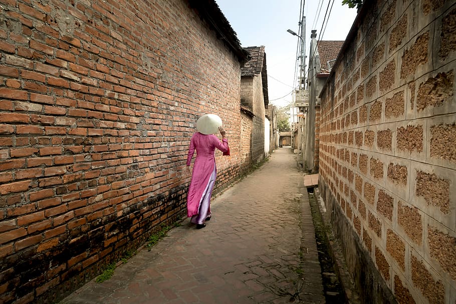 women's pink long-sleeved top walking near brick wall, the ancient village, HD wallpaper