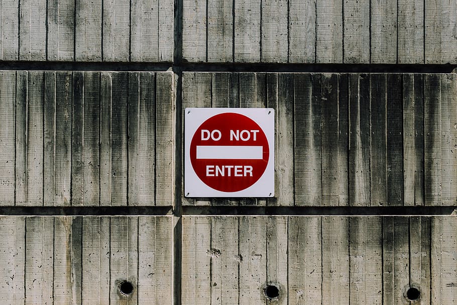 white and red do not enter signage, do no enter signage, building