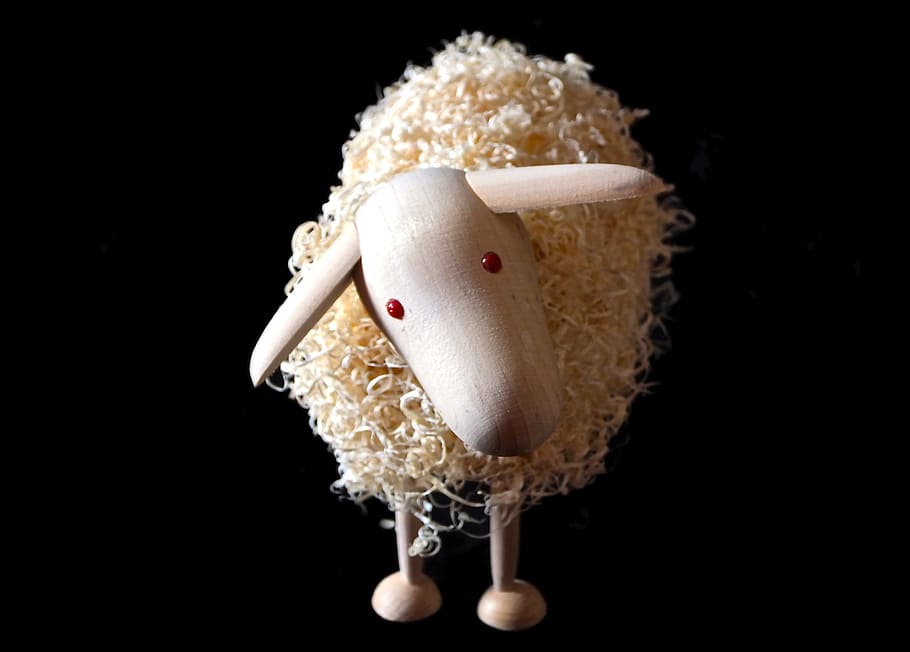 close-up photography of sheep wooden figurine, recycled sheep