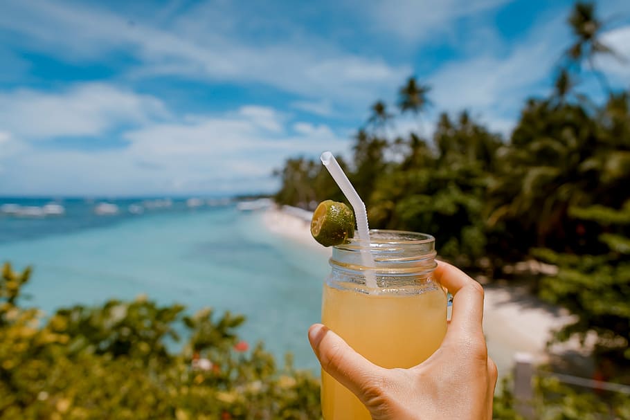 person holding lemon juice jar, sea, beach, white, sand, sunny HD wallpaper
