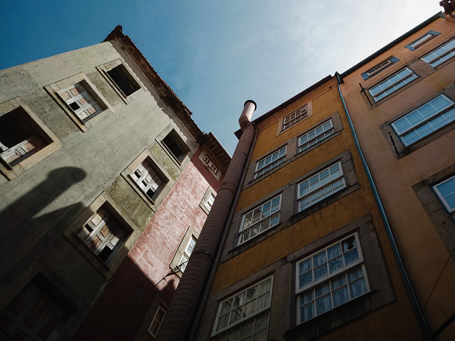 low angle photography of two buildings under clear sky, low angle view of brown building HD wallpaper