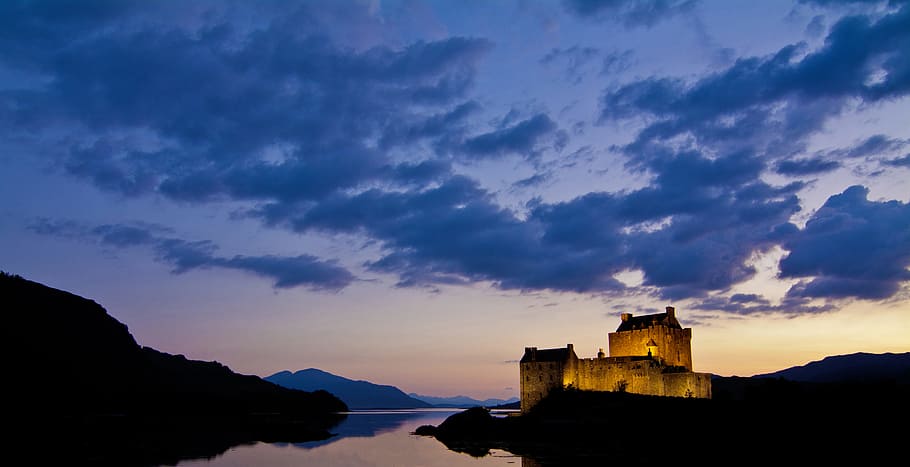 castle near body of water, brown castle under blue sky during daytime HD wallpaper
