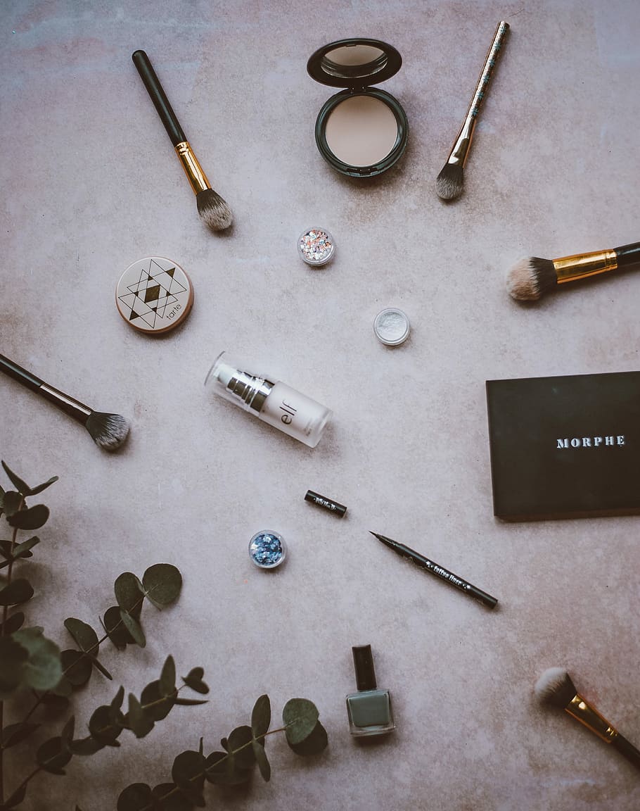 Make up flatlay, makeup palette, brush, foliage, nail polish HD wallpaper
