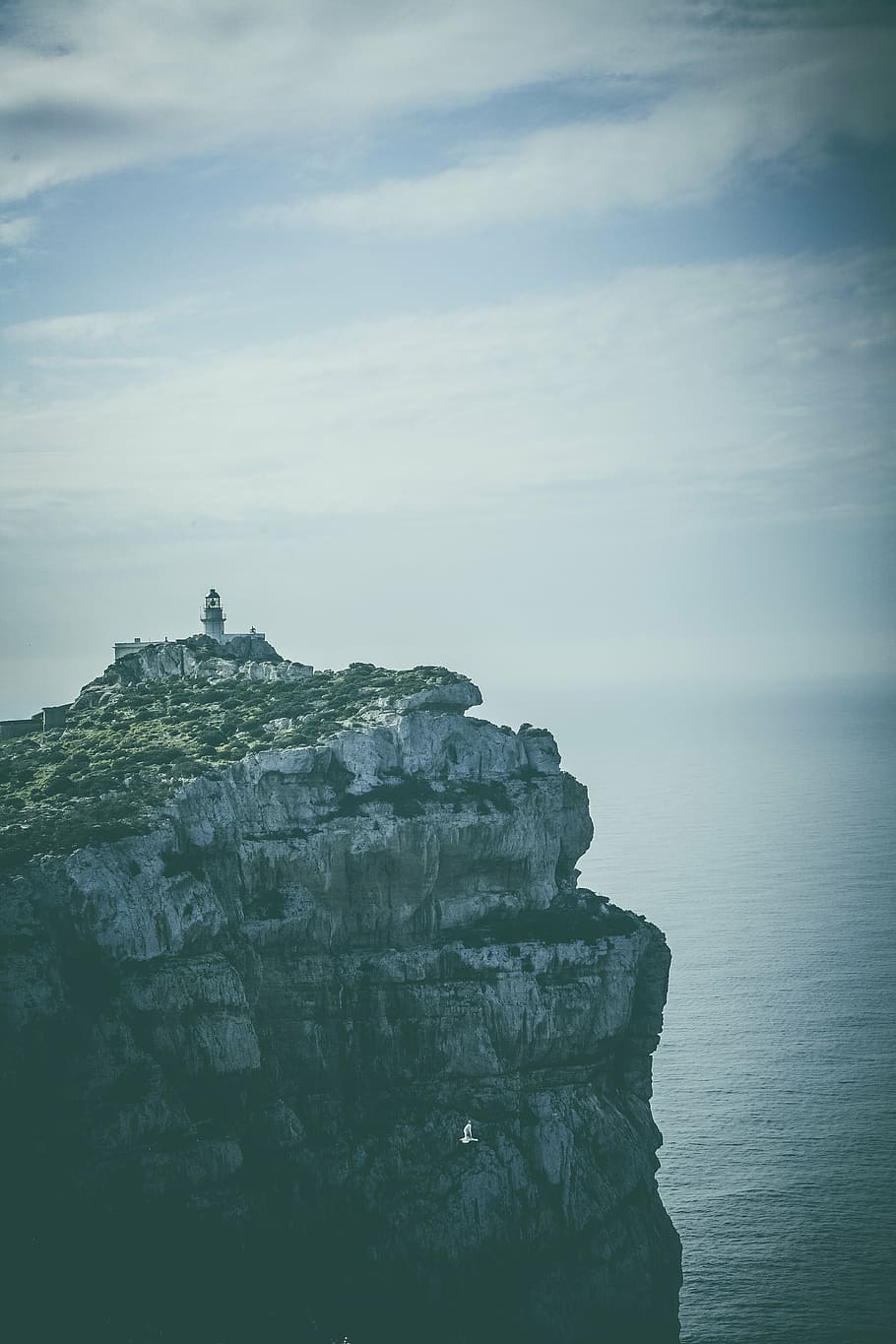 lighthouse on rock formation under white sky, hill, peak, summit HD wallpaper