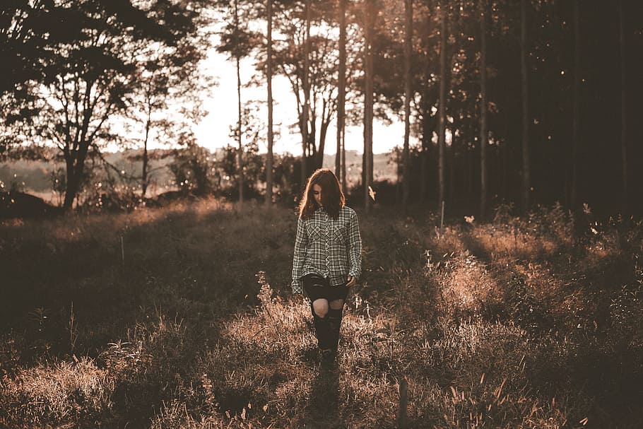 woman walking on brown grass field near trees, woman walking on grass field HD wallpaper