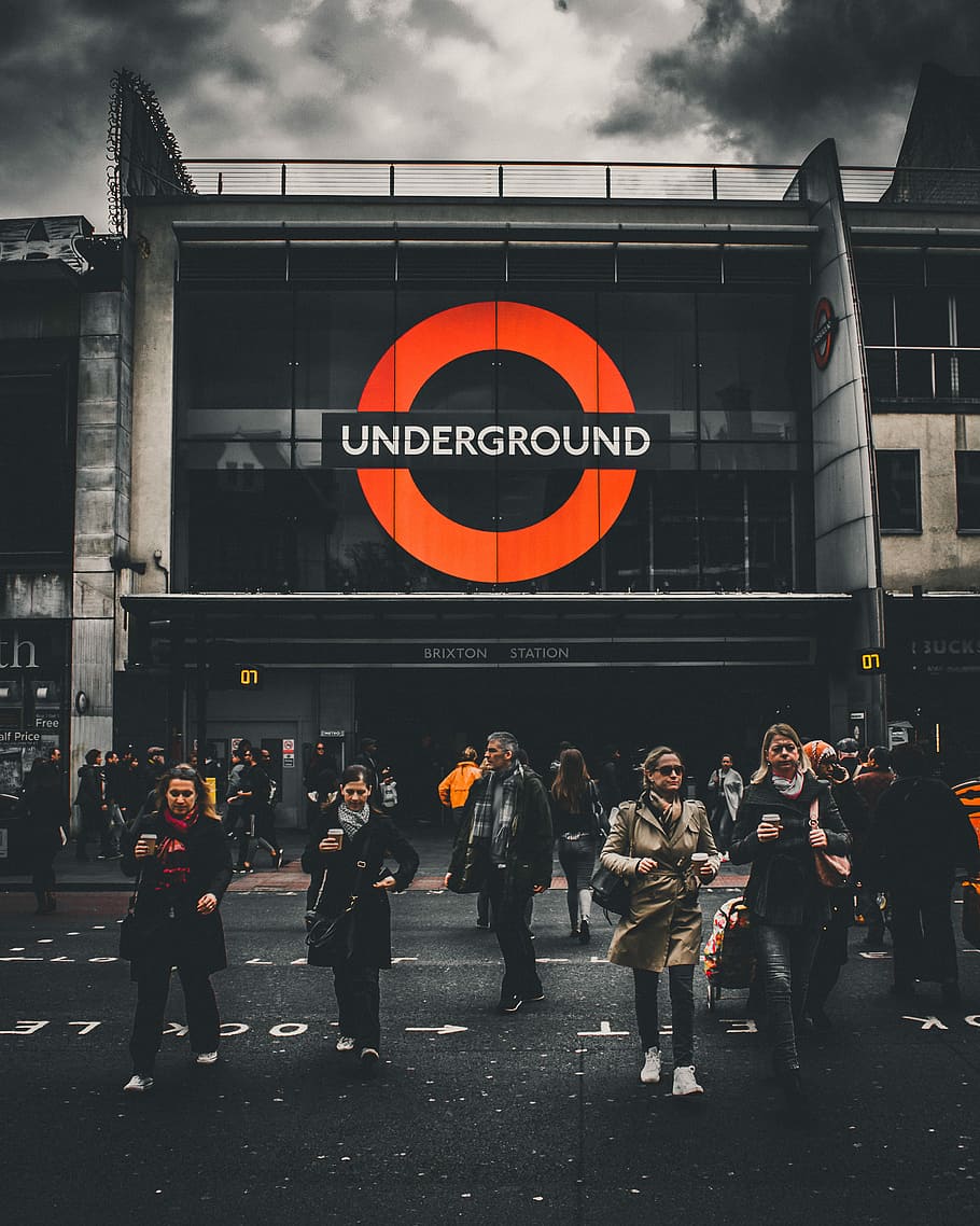 people walking in front of Underground labeled building, Underground Brixton Station building HD wallpaper