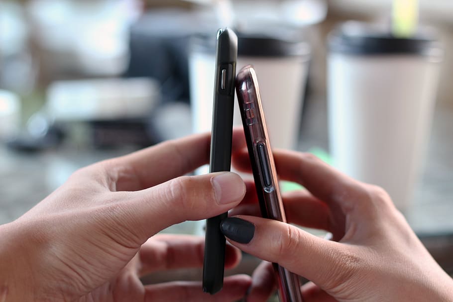 person holding black and brown Android smartphones, connect HD wallpaper