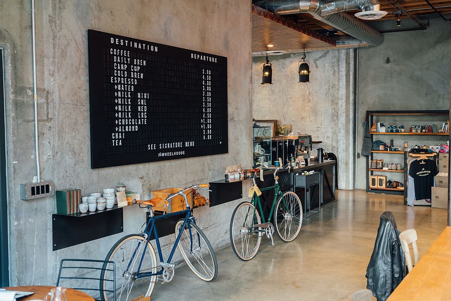 two bikes parked beside wall inside room, two green and blue bicycles beside wall rack inside building HD wallpaper