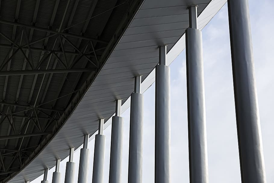grey concrete columns of building during daytime, selective photo of white and black concrete posts under white sky at daytime HD wallpaper