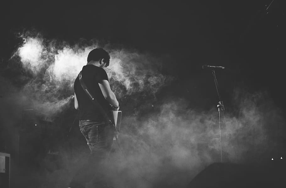 grayscale photography of man performing guitar on stage, greyscale photo of man playing guitar near microphone, HD wallpaper