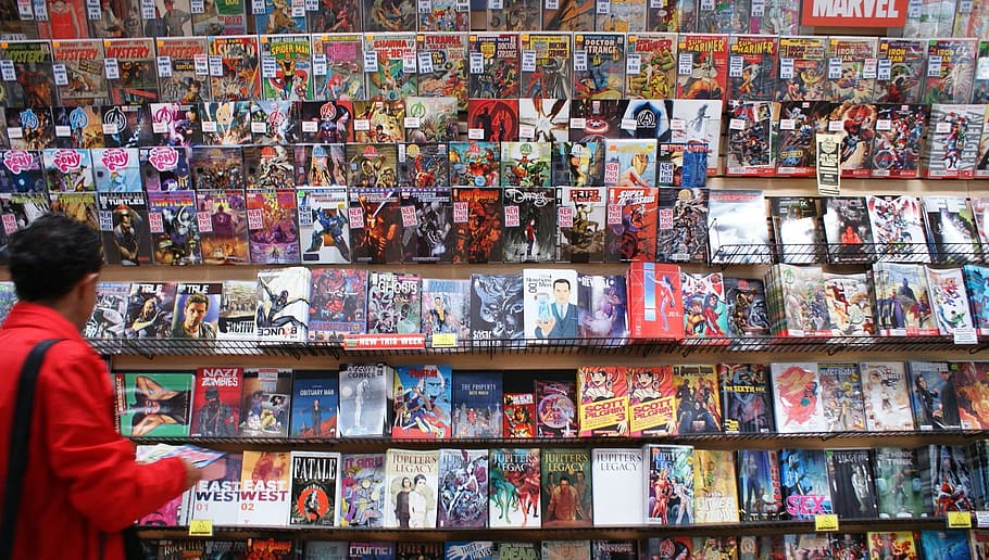 person standing in front of comic book stand, marvel, books, shop