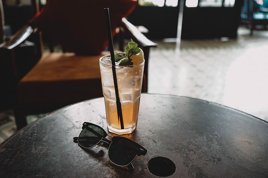 black Clubmaster-style sunglasses beside drinking glass, black framed Clubmaster-style sunglasses beside drink on table, HD wallpaper