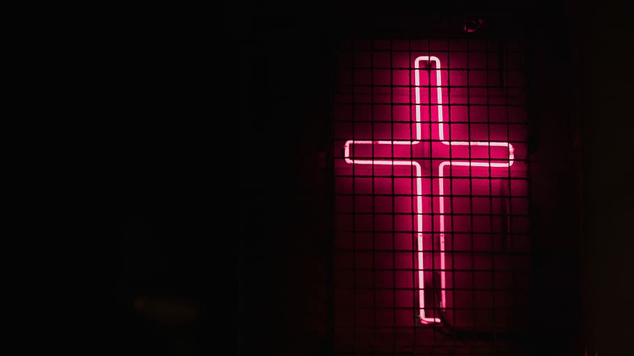 pink cross neon signage, turned on red cross neon signage, fence