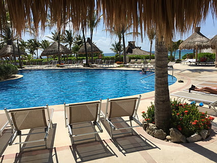 three brown lounge chairs beside below-ground pool, cancun HD wallpaper