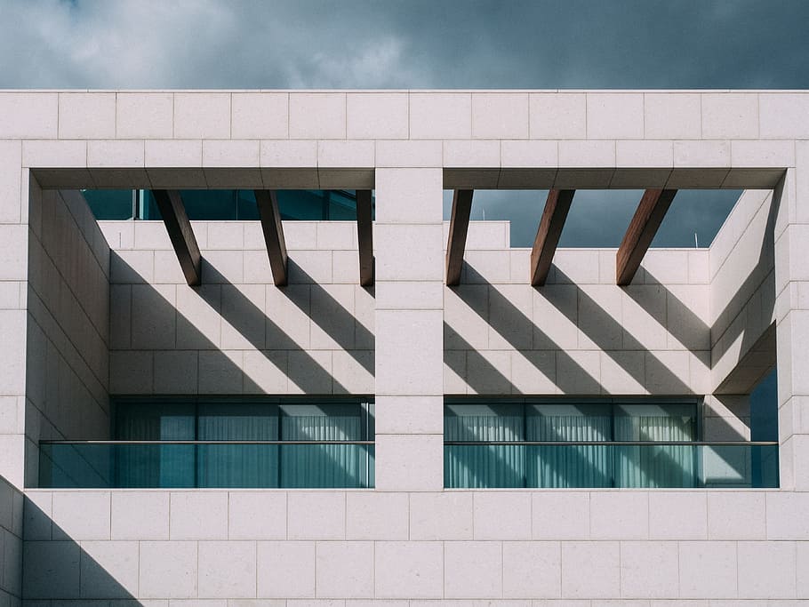 closeup photo of white and blue building, white concrete establishment photograph HD wallpaper