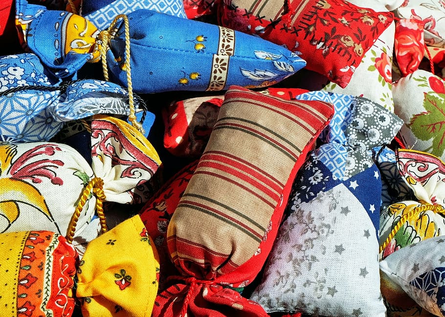 close up photography of assorted-color throw pillows, bag, scented sachet, HD wallpaper