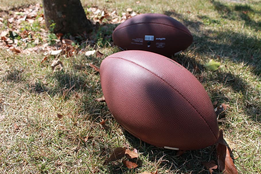 two brown football balls on ground during daytime, american football, HD wallpaper