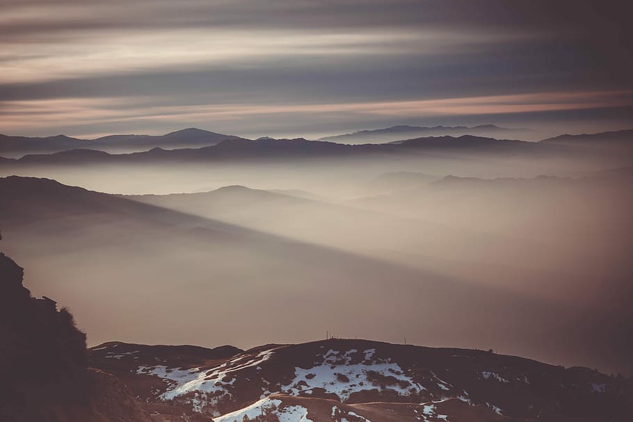 fogs at mountains during golden hour, photo of mountain under white sky HD wallpaper
