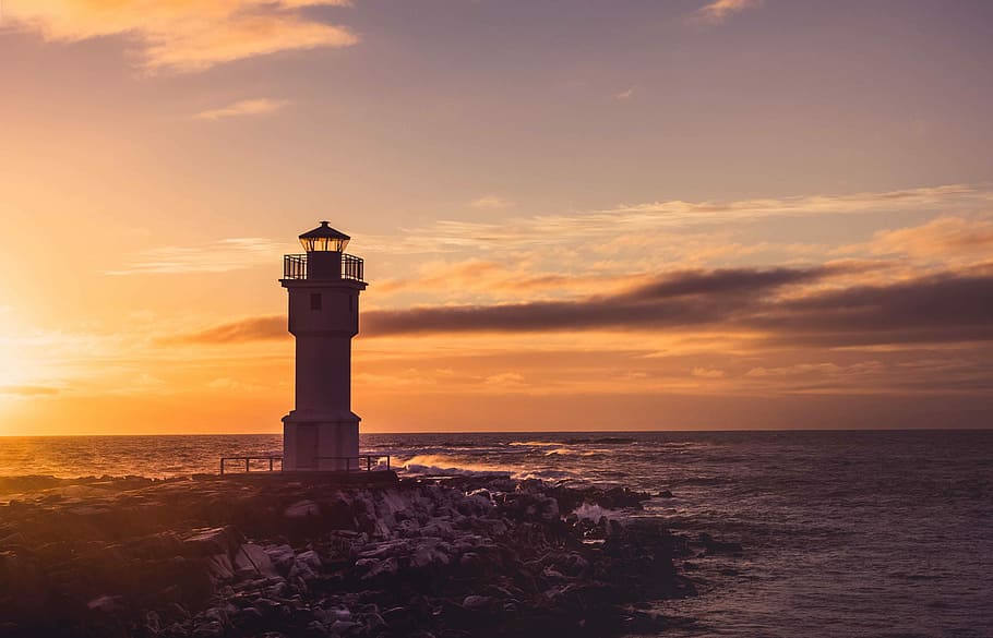 white lighthouse tower under yellow and white cloudy skies at sunset, white and black lighthouse near tree HD wallpaper