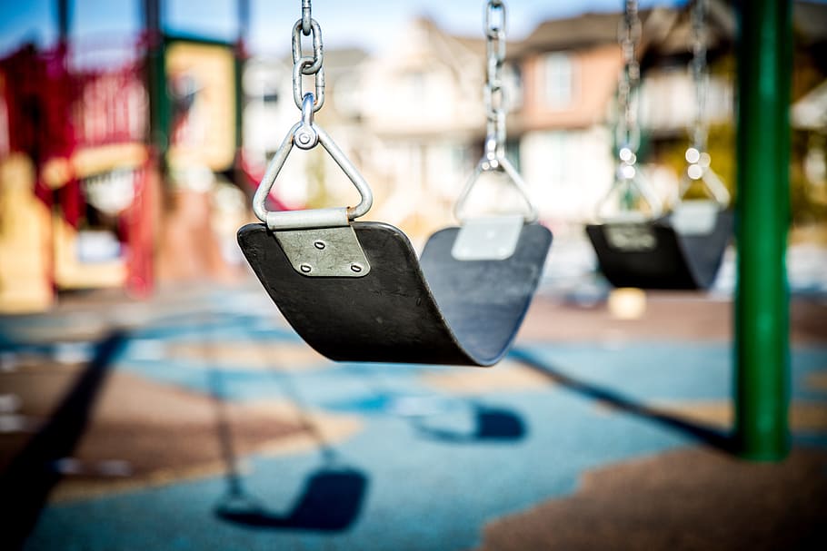 black swing in tilt shift photography, playground, children playing