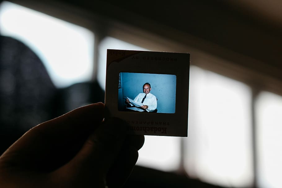 person viewing the image of man, photo, slide, male, technology HD wallpaper