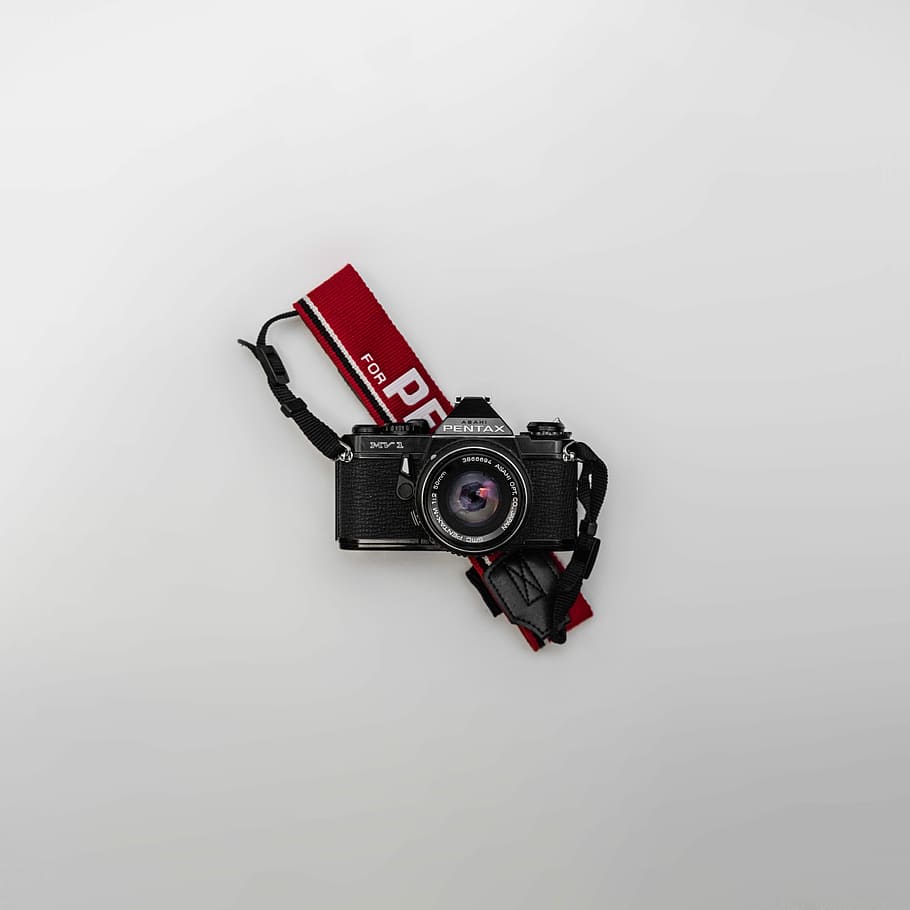 black Pentax camera on white background, black and gray camera on white surface HD wallpaper
