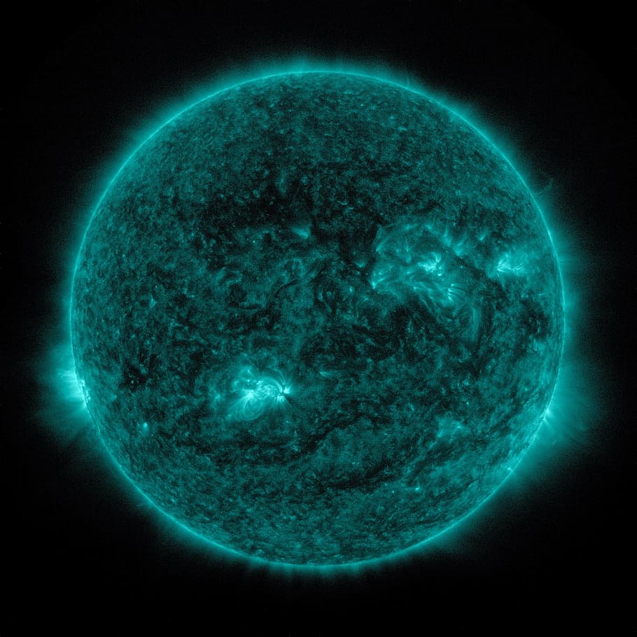 green planet against black background, solar flare, sun, eruption