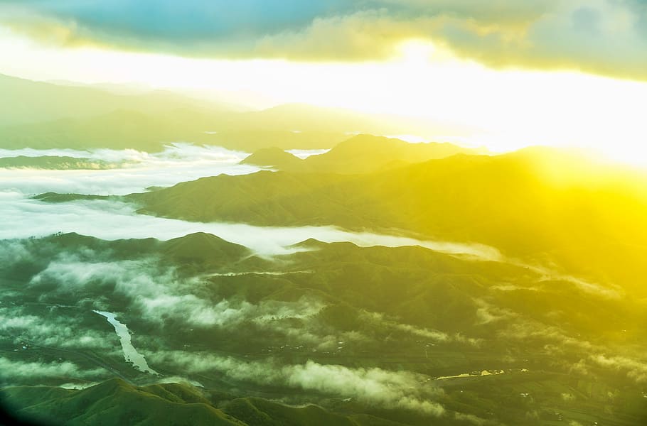 sea waves during day time photography, aerial photography of two divided mountains under white clouds blue skies golden hour HD wallpaper
