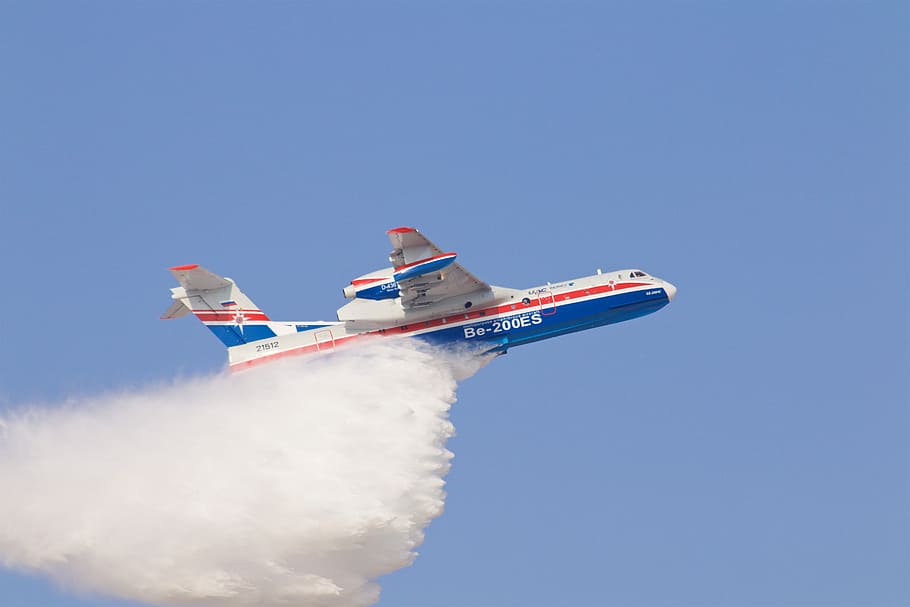 white and blue airplane on blue sky, white and blue airplane dropping water HD wallpaper