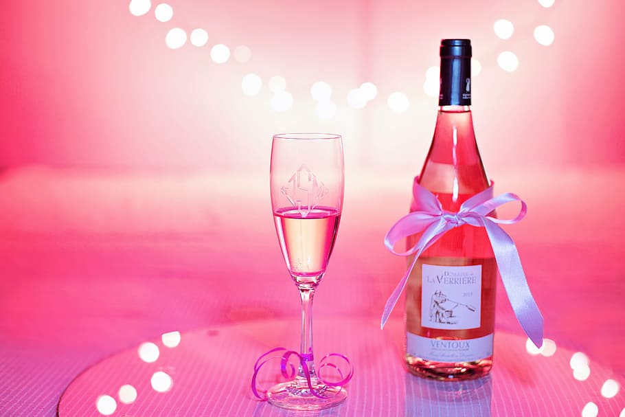 white labeled glass bottle near wine glass, pink wine, champagne