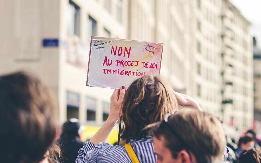 woman holding card, person holding signage, protest, march, french HD wallpaper