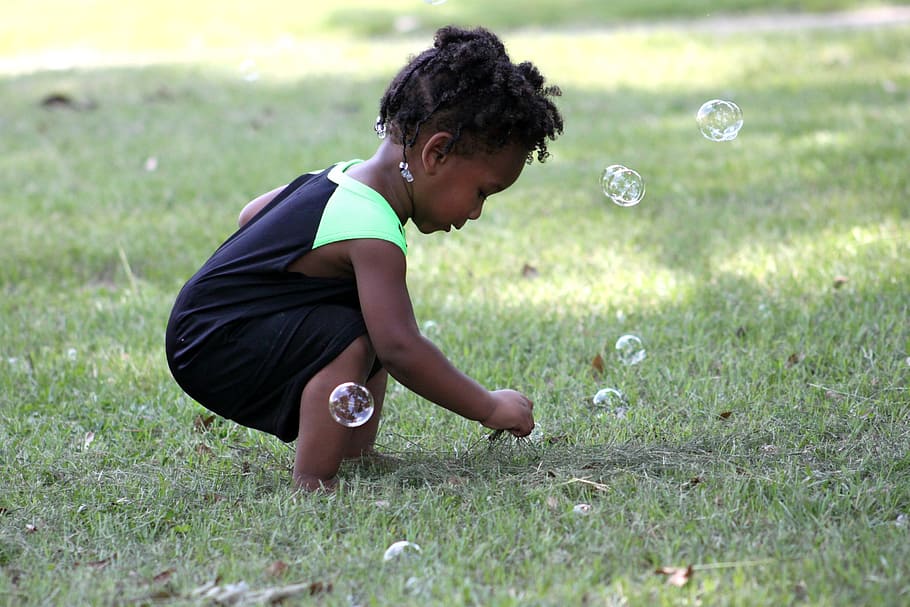 girl playing bubbles on green grass field, young, child, small