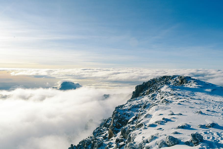 mountain covered by snow near sea of clouds, aerial view photo of mountains covered with snow HD wallpaper