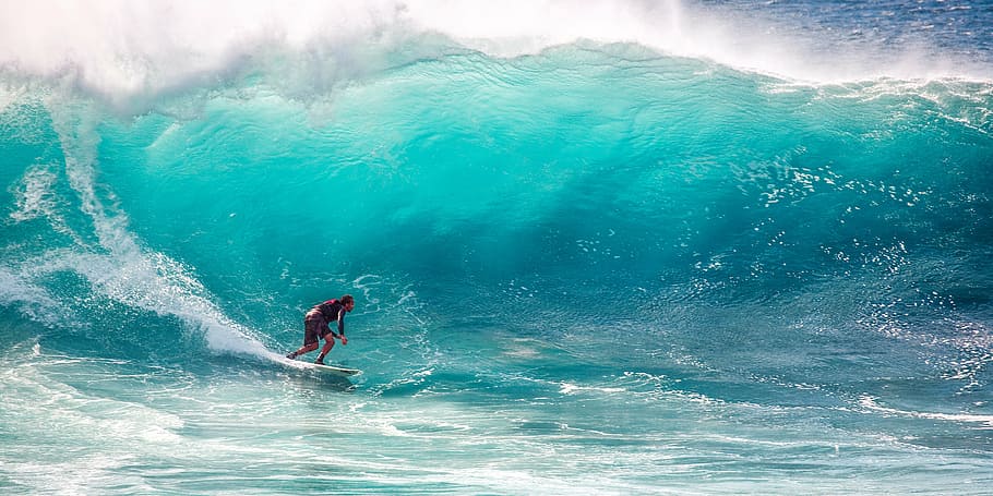 man in black long-sleeved shirt surfing on high ocean waves, big waves