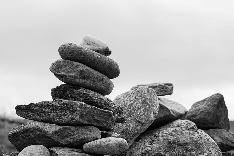 grayscale photo of pile of gray stones, black stone, formation