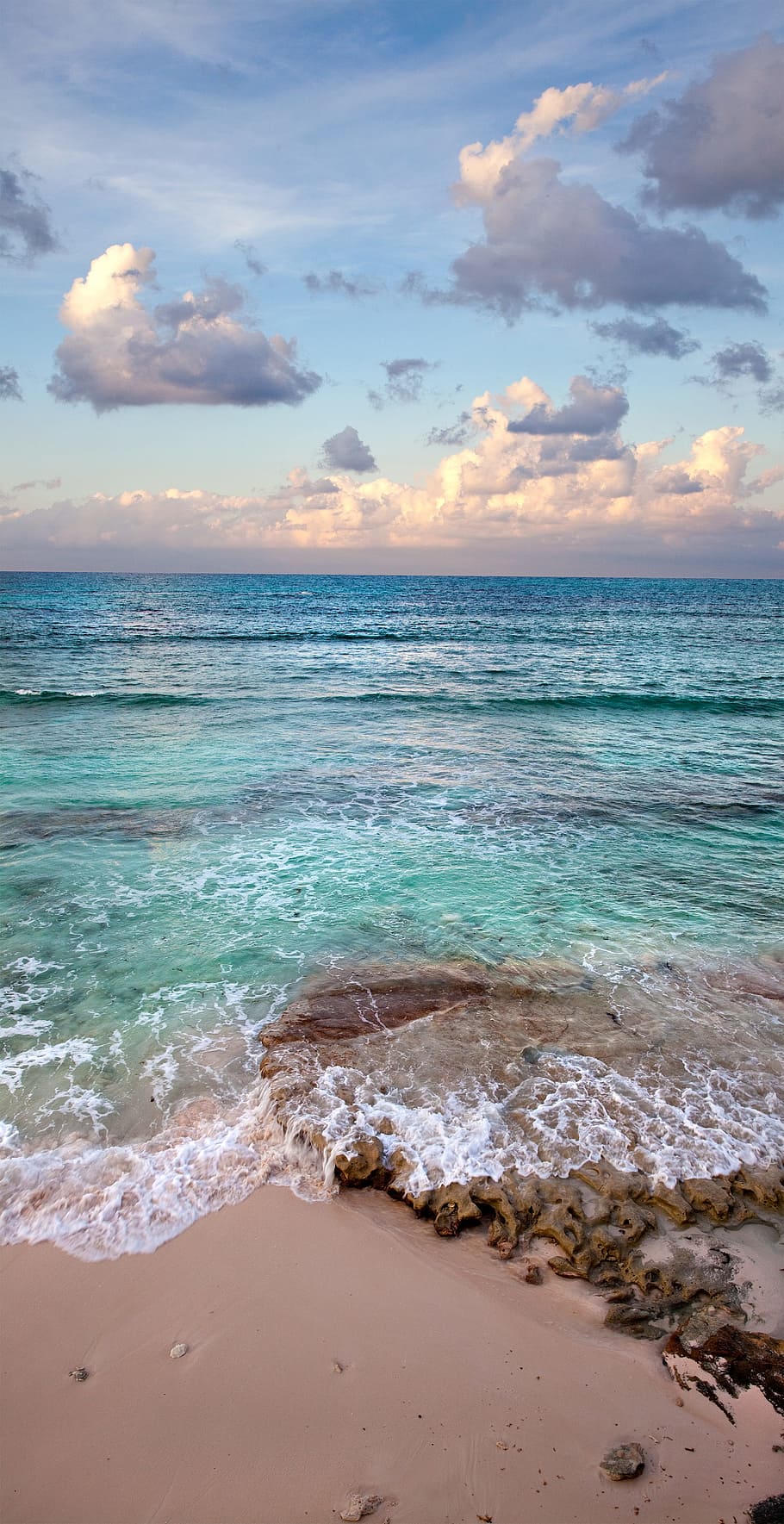 teal seawave under blue and white sky, sunset, beach, caribbean