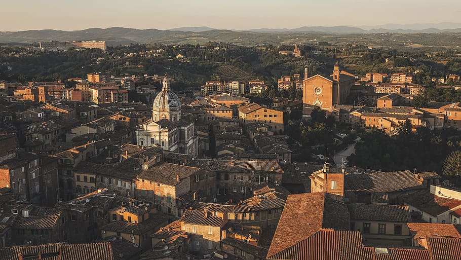 Beautiful aerial view by a drone of Siena, Italy. Charming old buildings showcase western Europe's architecture., town buildings HD wallpaper