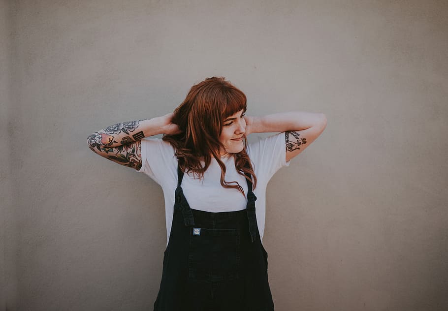 brown haired woman in black dungaree and white shirt standing near wall, HD wallpaper