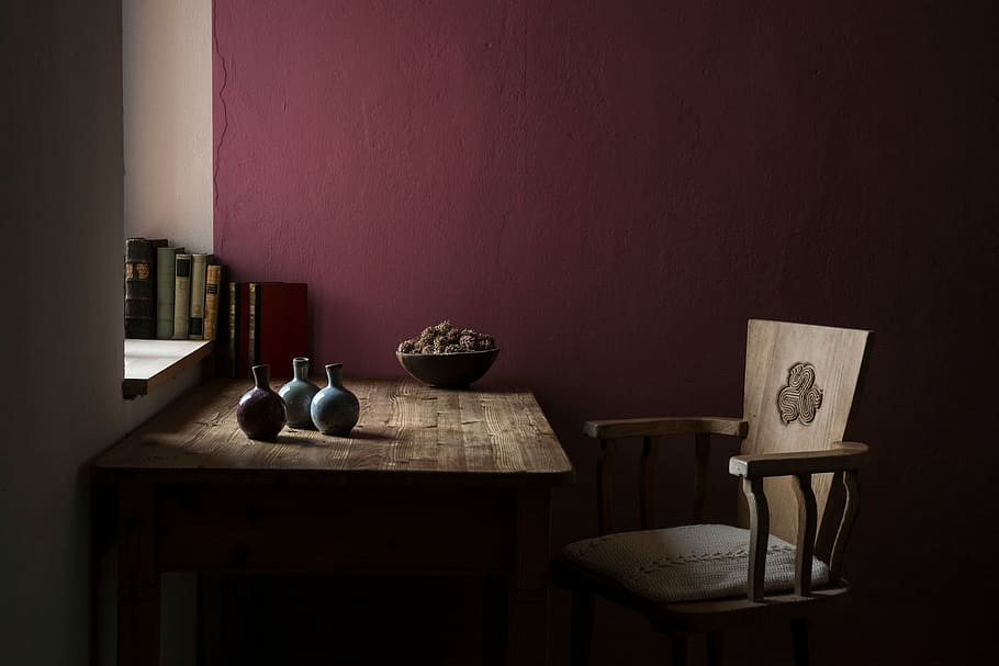 three vases on table beside chair inside maroon painted room, chair beside desk near wall inside room HD wallpaper