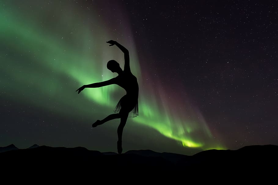 silhouette photography of ballet dancer in northern lights, ballerina