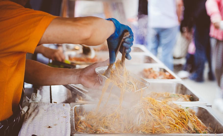 A man serving street food in Letchworth Garden City, man pouring noodles on bowl, HD wallpaper
